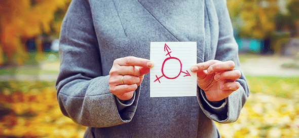 Person holding drawing of gender symbol